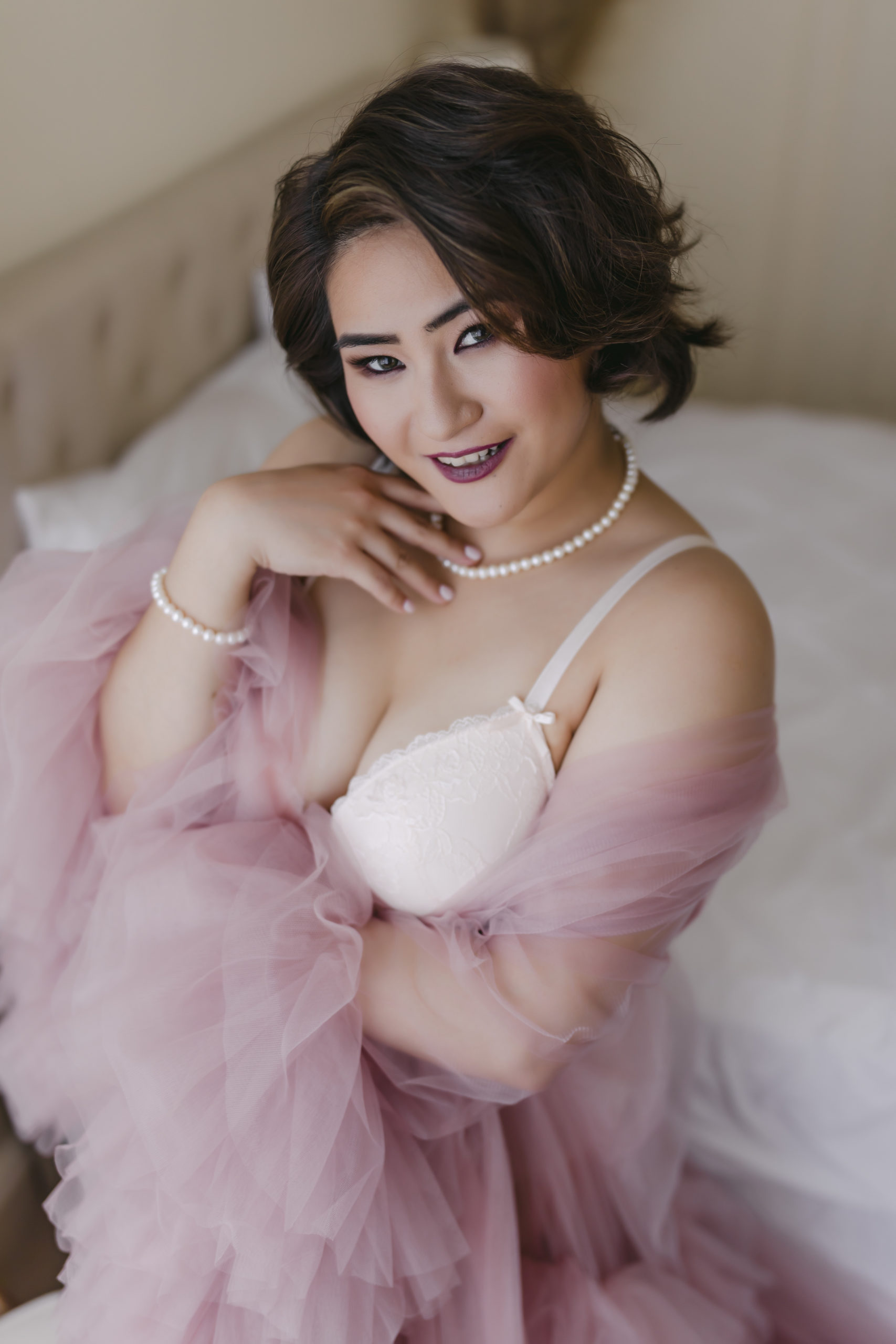 What is boudoir photography? Woman wearing pink tulle robe with Hollywood glamour hairstyle